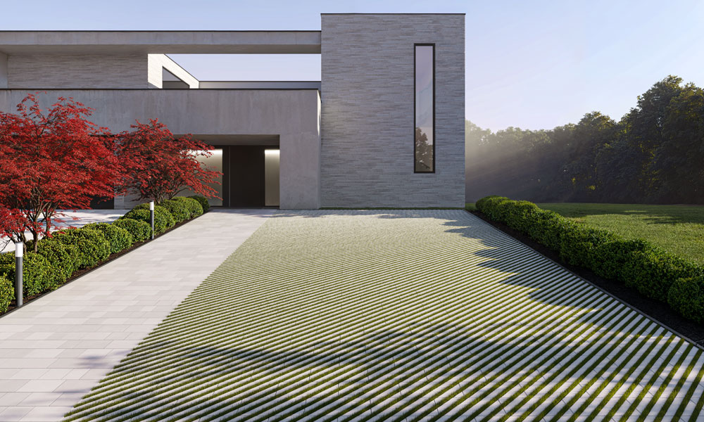 Rasenplatte Verso grau kombiniert mit Arret B20 VG4 grau Rasenplatte Verso liegt als Ökoliner bzw. Rasenliner auf einer Parkplatzfläche vor einem schönen Haus.