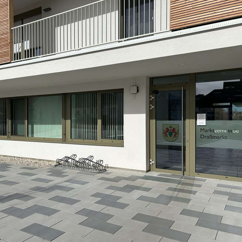 Gemeindezentrum Draßmarkt Linea VG4 Pflaster platin hell und dunkel Vor dem Eingang der Marktgemeinde Draßmarkt Linea VG4 Pflaster platin hell und dunkel, klare Flächenstruktur, Friedl Steinwerke.