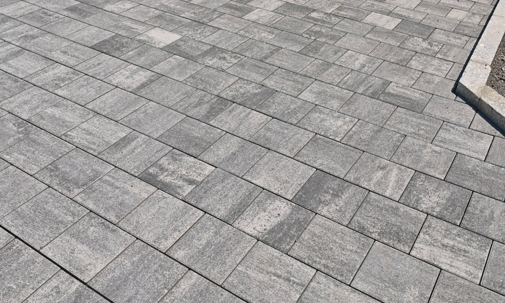 Parkettpflaster granitgrau-schattiert von Friedl Steinwerke verlegt in einer Einfahrt – eine elegante Lösung mit moderner Farbgebung für Außenflächen.