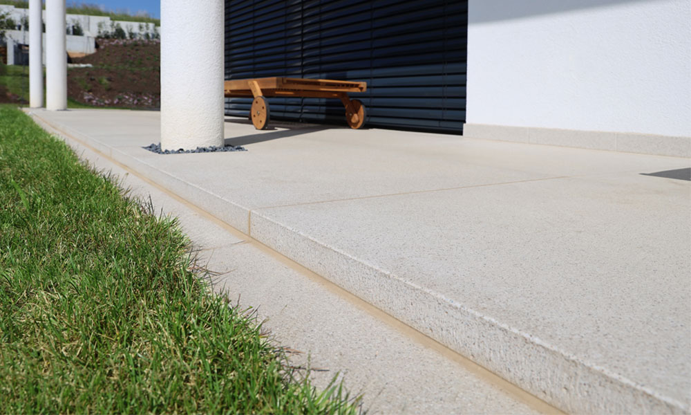 LIV quarzit von Friedl Steinwerke als großformatige Terrassenplatten und Stufenlösung im Übergang zwischen Haus und Garten.
